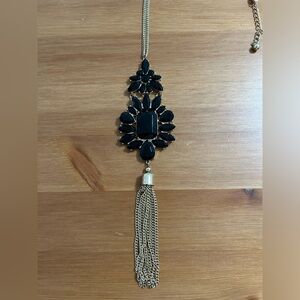 Long fashion necklace with tassel in gold finish and black stones